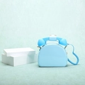 Detailed view of the sky blue retro telephone handbag with iconic spiral cord strap - Light Blue