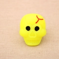 Glow-in-the-dark yellow skull ring for Halloween parties with black eyes and red detail - Skull