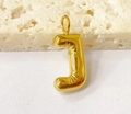 Macro shot of 3D puffy gold letter J pendant with high-shine metallic finish on stone - Letter-J / Steel