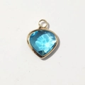 Macro view of blue heart gemstone pendant with gold metal frame for jewelry making - Gold-March