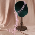 Elegant bridal headpiece with pink faux pearls and layered tassel beads on a model - Pink