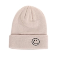 Winter knitted beanie in light beige featuring a black embroidered smiley face on the cuff - Beige