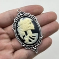 Pendaglio cammeo con teschio gotico in cornice d'argento vintage tenuto in mano - Cornice Argento Vintage