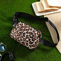 Leopard print waterproof waist bag detail with black adjustable strap on grass background - Leopard Print