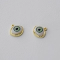 Macro detail of alloy evil eye charms with green pupils and polished gold plating - KC Gold (Green Eye)