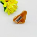 Macro detail of cartoon nose pencil sharpener showing inner metal blade and socket - Nude