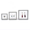 Three grey floating jewelry display boxes with PE film in various sizes for earrings - Gray