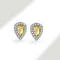 Macro shot of silver stud earring featuring pear-cut yellow gemstone and zircon halo - 925 Silver / Citrine Yellow (November)