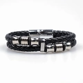 Macro detail of black braided leather bracelet with silver magnetic metal clasp - Steel