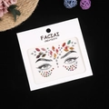 Detailed view of colorful face jewels stickers on white card for music festival makeup - Multicolor AB