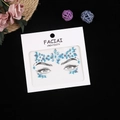 Close-up of blue rhinestone face jewels set for forehead and eyes on white card - Blue/Aurora Blue