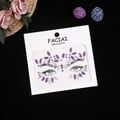 Macro detail of purple and clear acrylic facial jewels on standardized backing card - AB Purple