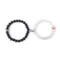 Macro detail of magnetic couples bracelets with matte black and translucent stone beads - Matte Black & Moonstone with Crown & Round Magnet