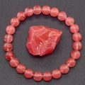 Close-up of natural pink strawberry quartz stretch bracelet with raw crystal gemstone - Strawberry Quartz