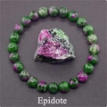 Macro shot of natural epidote bead bracelet with raw green and red stone specimens - Ruby Zoisite