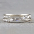 Silver criss-cross ring with alternating round and baguette cubic zirconia stones - US 7 / White Gold