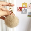 Fluffy mink fur pompom keychain in beige with gold lobster clasp accessory - Daylight White