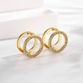 Macro detail of gold geometric hollow hoop earrings with cubic zirconia and polished finish - Ear Buckle / Gold White Round