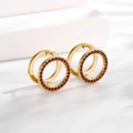 Macro shot of gold circular earrings with red zircon inlays on white stairs background - Ear Buckle / Gold Red Round