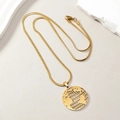 Detailed view of a gold-plated hollow earth globe pendant on a flat snake bone chain - Earth