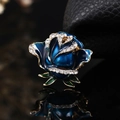 Dark blue enamel rose brooch with white rhinestones and green leaves on gold base - 8328 Blue