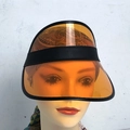 Orange transparent PVC sun visor hat with black leather trim shown on model head - Orange-Elastic Band