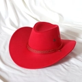 Classic bright red faux suede cowboy hat with braided cord on white silk background - M / Red