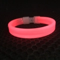 Pink glowing LED bracelet for parties with a secure white plastic buckle closure - Red