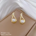 Macro detail of gold earrings with white pearls and diamonds on a brown jewelry box - Stud Earrings (B530)
