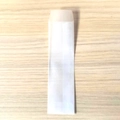 Translucent long vellum paper bag for jewelry or pens on light wood background - 3.5*10.8cm