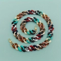 Colorful acrylic chain strap with gold lobster clasps spiraled on a mint green background - B301 Rhombus Mixed Colors