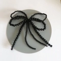 Detail of elegant black bead bow ornament with dangling tassels for shoe decoration - Black Double Bow