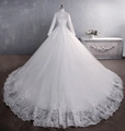 Luxury long-sleeved lace wedding dress with high neck, button back and cathedral train - Trailing