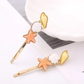 Horquillas doradas de estilo marino con detalles de conchas y estrellas de mar - Par Blanco