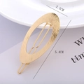 Macro view of gold oval hair clip with brushed metal texture and 5.4cm length detail - Gold - Brushed Oval