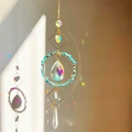 Close-up of crystal suncatcher casting rainbow light reflections on a warm wall - Turquoise