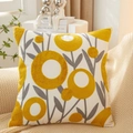 Square cotton pillow with yellow floral tufted embroidery on beige knitted blanket - Calla Lily Pattern