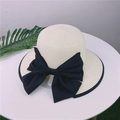 Elegant beige straw sun hat with large black bow and ribbon trim for beach outings - Adjustable M (56-58cm) / Creamy White