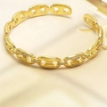 Detailed macro view of gold chunky chain bracelet with micro-pave cubic zirconia accents - Anchor Link Style