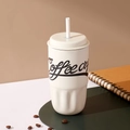 Detail of cream-colored 316 stainless steel coffee cup with straw and textured base - 500ml / White