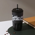 Detail of matte black 316 stainless steel coffee cup with straw and textured grip - 500ml / Black