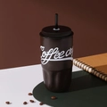 Detail of a dark brown 316 stainless steel coffee mug with black lid, straw, and wave base - 500ml / Brown
