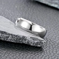Macro shot of minimalist silver stainless steel ring on dark rock and leather - US 7 / Plain Silver