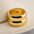Macro shot of 18K gold plated double-layered stainless steel ring on a white plate - US 5 / Gold