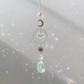 Detail of sun and moon crystal suncatcher reflecting colorful light on a white wall - Dragon Eye Style
