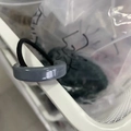 Détail d'un chouchou géométrique minimaliste en acétate gris avec élastique noir - gris foncé