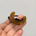 Macro detail of amber acetate semi-circle hair ring with strong black elastic band - Brown