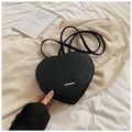 Black heart-shaped backpack featuring rich rabbit embossed pattern and metallic accents - Black