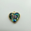 Macro detail of a 18K gold-plated heart pendant with abalone shell and purple gem - Heart Purple Zirconia (Abalone Shell)