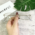 Detail of vintage metal square sunglasses frame held against a minimalist background - Silver Frame Clear Lens